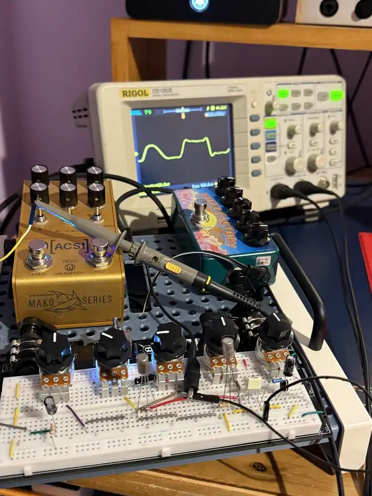 picture of electronics workbench, with oscilloscope and assorted electronics